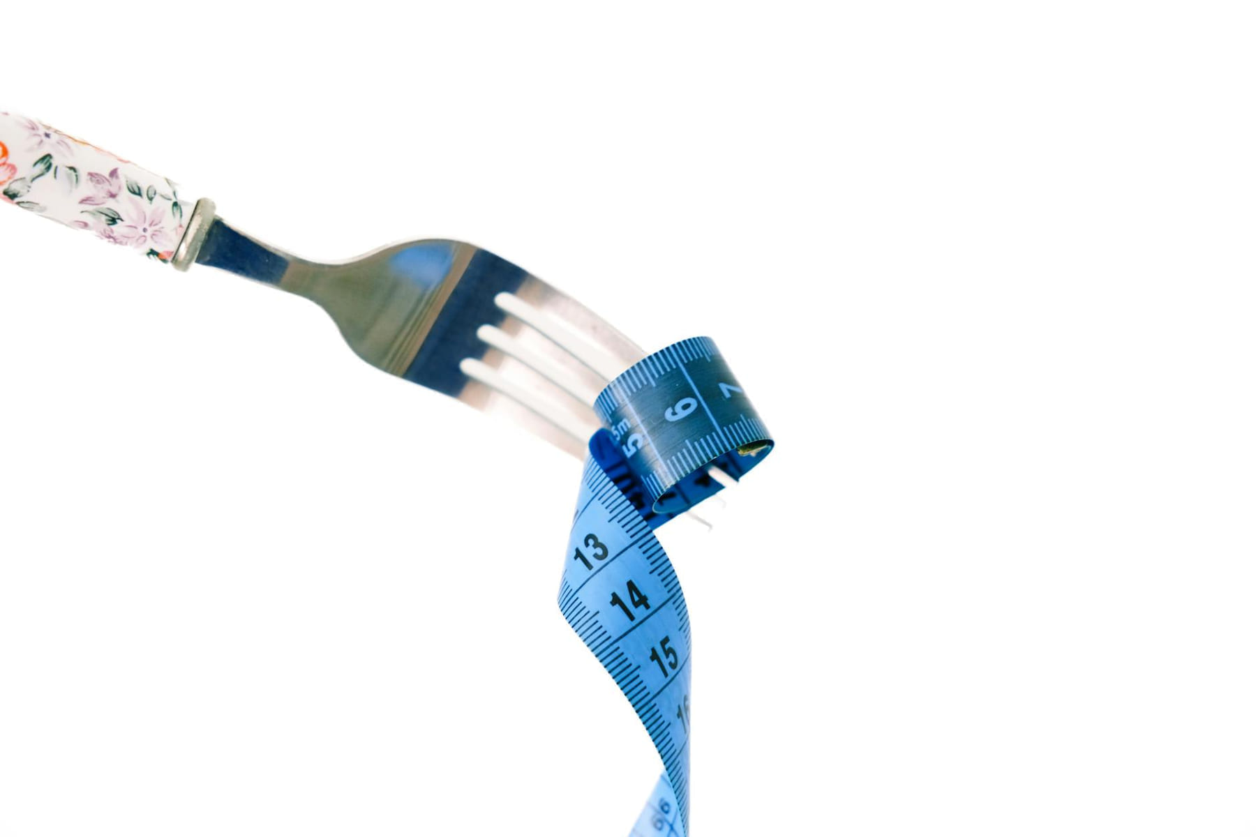 A fork twirls a blue measuring tape, symbolizing weight management and health. on Think Lean Live Strong