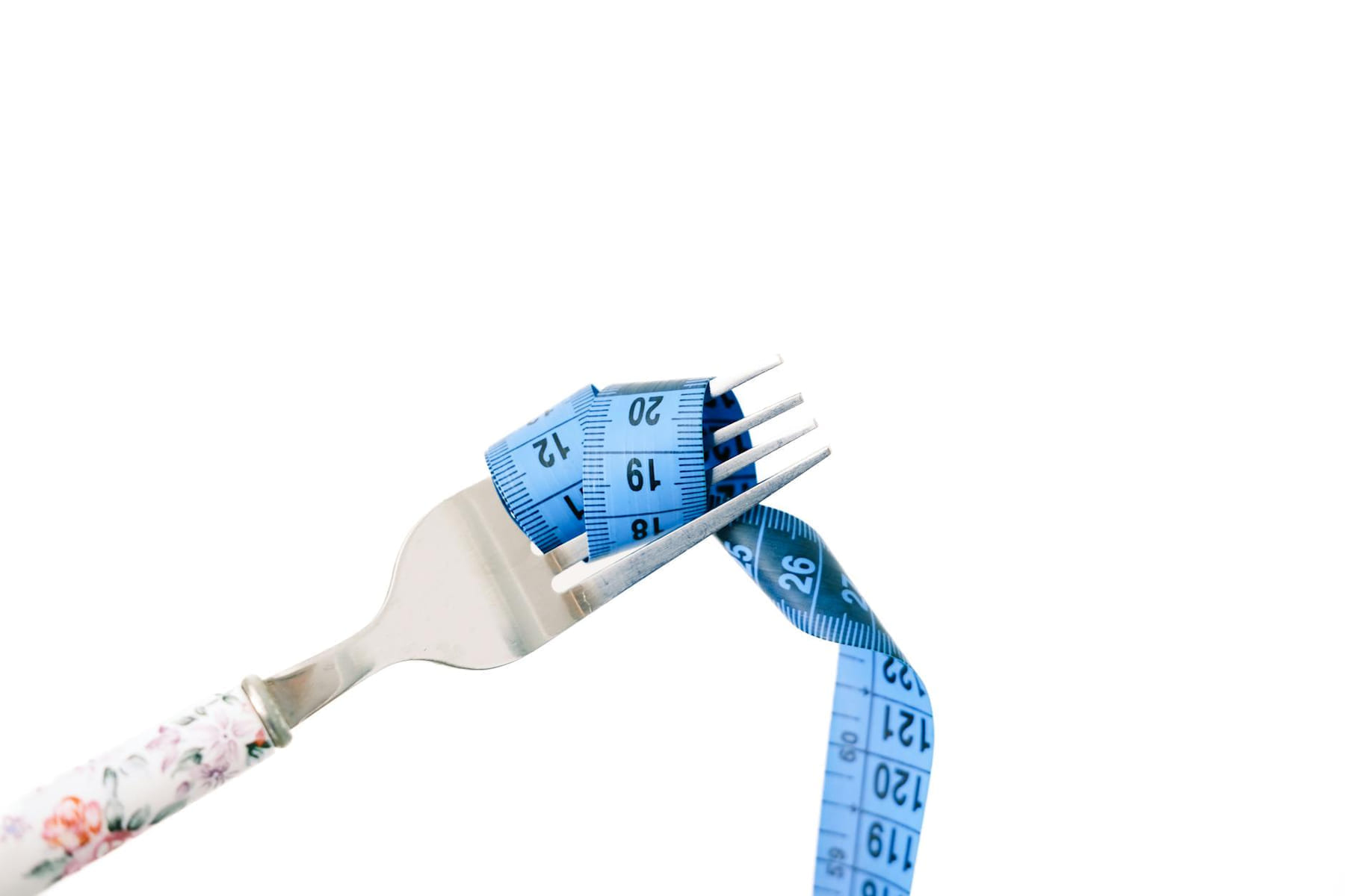 A fork entwined with a blue measuring tape, symbolizing dieting and weight management. on Think Lean Live Strong