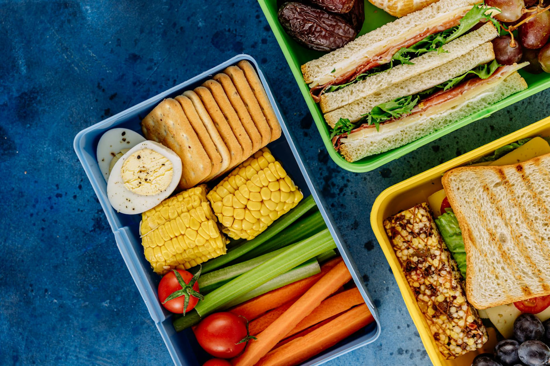Colorful lunchboxes featuring sandwiches, vegetables, and snacks for healthy eating. on Think Lean Live Strong