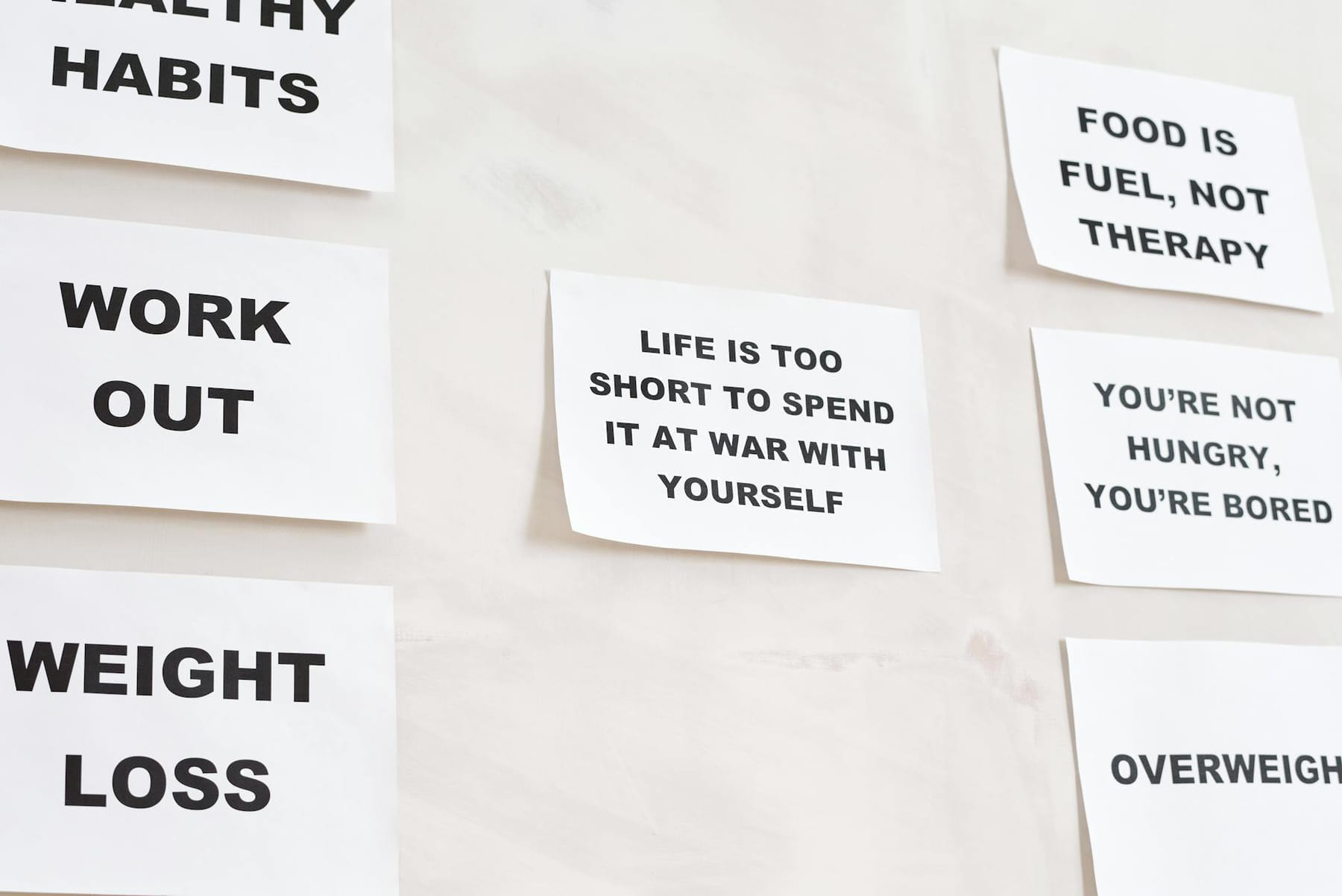 Motivational quotes on white paper promoting healthy habits and lifestyle changes. on Think Lean Live Strong