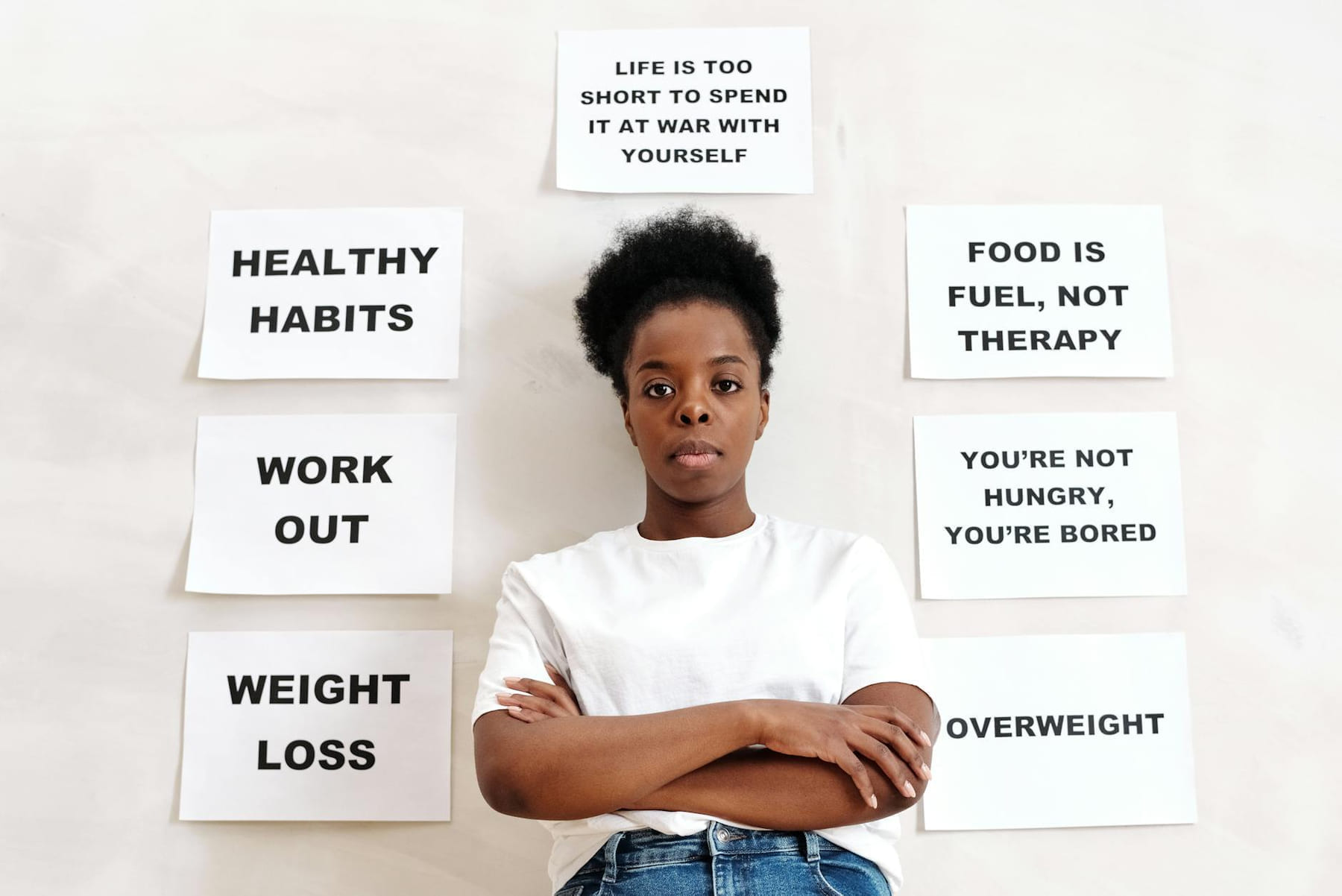 Confident woman stands surrounded by motivational messages about healthy living. on Think Lean Live Strong