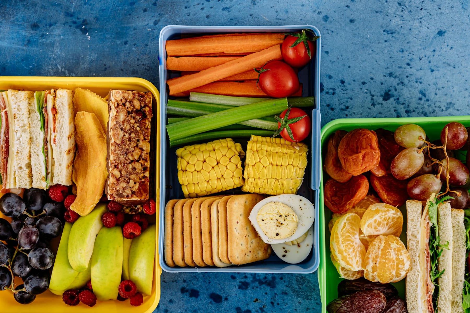 Vibrant assortment of sandwiches, fruits, and veggies in lunchboxes. Perfect for healthy meal prep inspiration. on Think Lean Live Strong